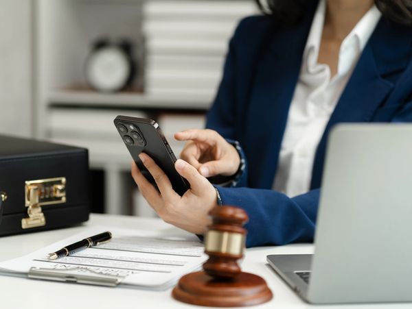 Notary agent with gavel and phone in office.