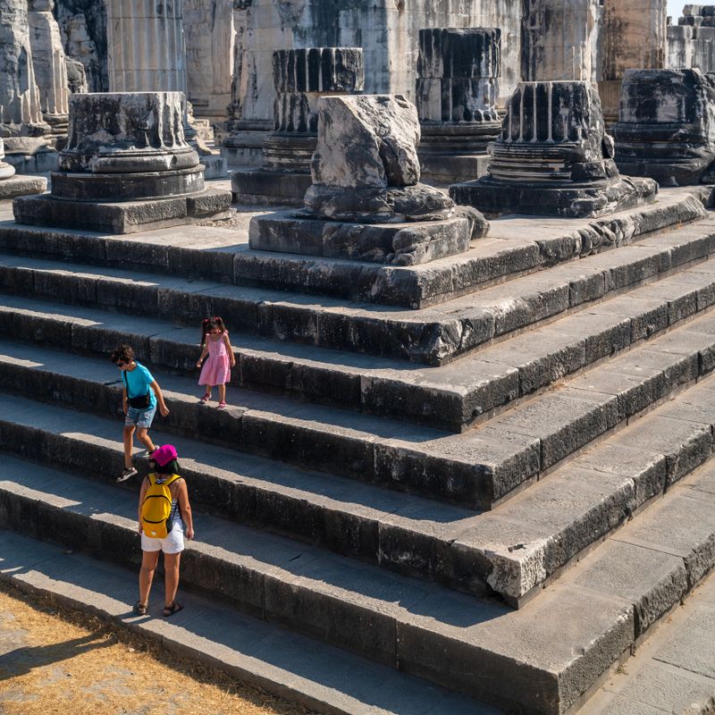 Full length photo of mother, 10 years old son and 5 years old daughter visiting ancient Greek city of Didyma in Aydin Province, Turkey. Shot during day time with a full frame mirrorless camera.