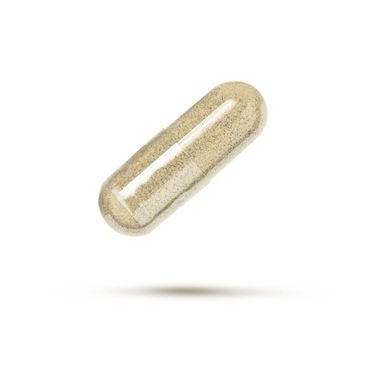 Close-up of a capsule filled with powdered supplement.