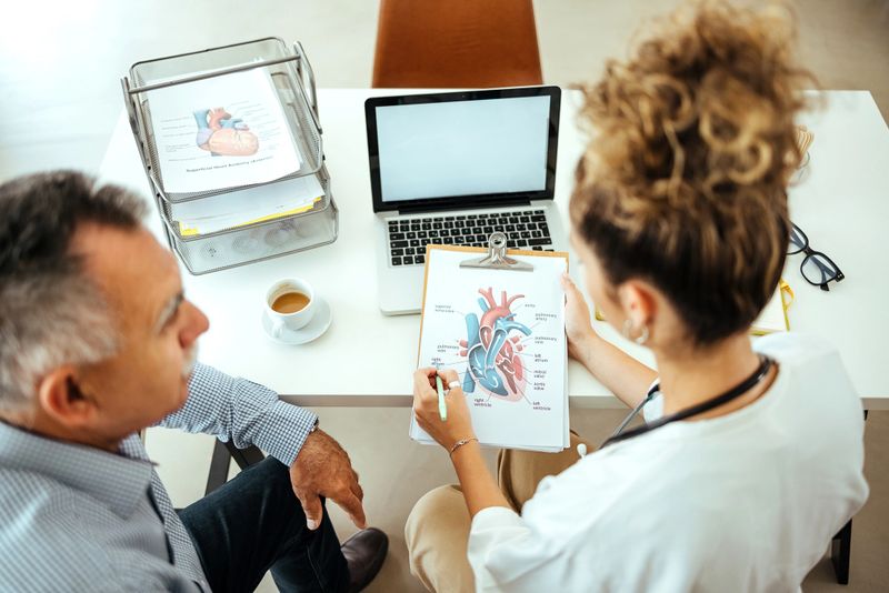 Patient and the doctor look at the results of the heart