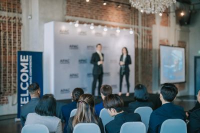 Business presentation with audience listening.