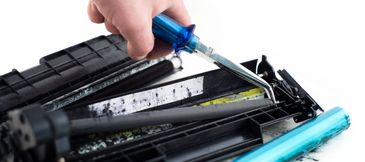 Various printers and printing supplies arranged together.