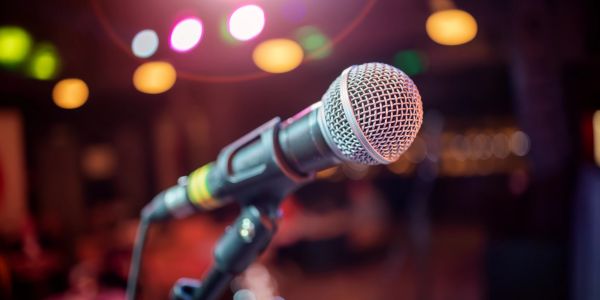 Close-up of a microphone with colorful stage lights.
