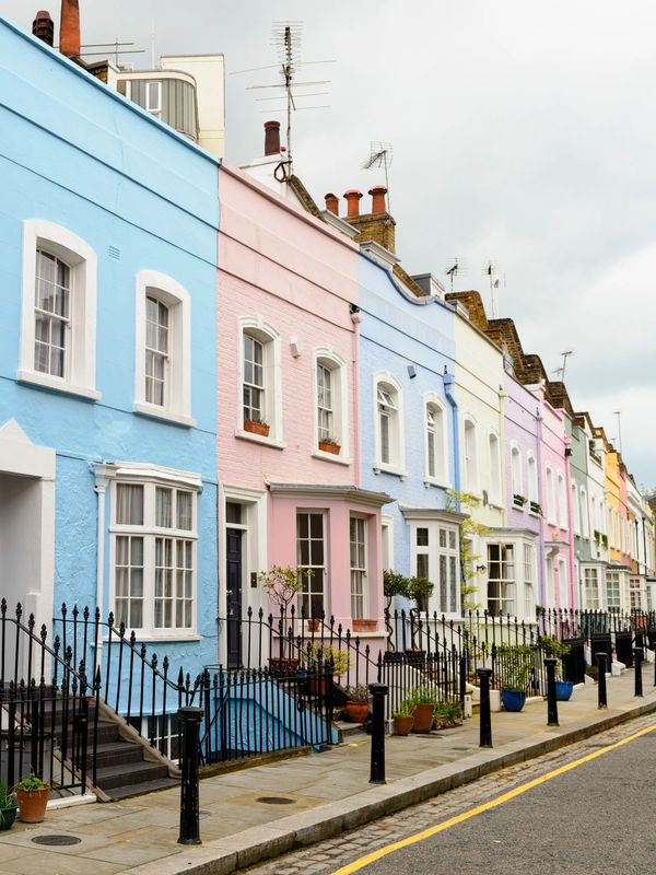 Colorful row of pastel-painted townhouses along a quiet street.