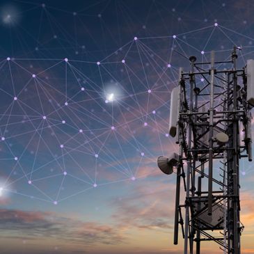 Telecommunication tower with digital network connections at sunset.