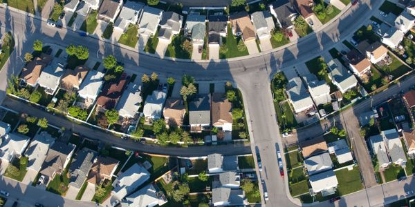 Aerial view of a suburban neighborhood with houses and streets.