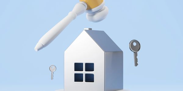 A house model with floating keys and a gavel above it.