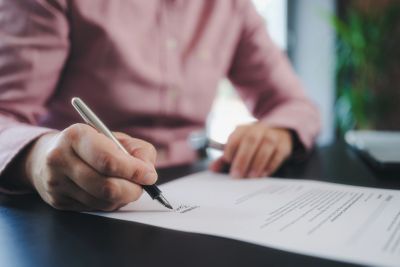 Legal professional reviewing documents with coffee