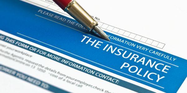 Insurance policy document with a pen.