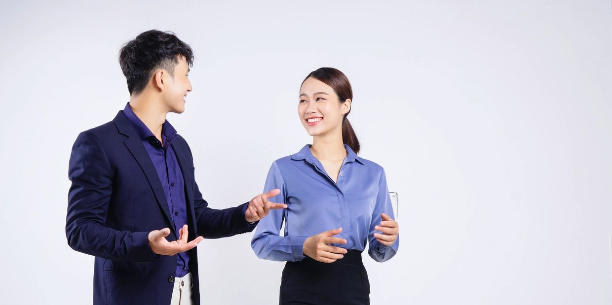 Two people engaging in a friendly conversation, smiling.
