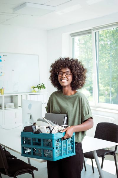 School staff using a dumpster rental for schools for campus cleanup.
