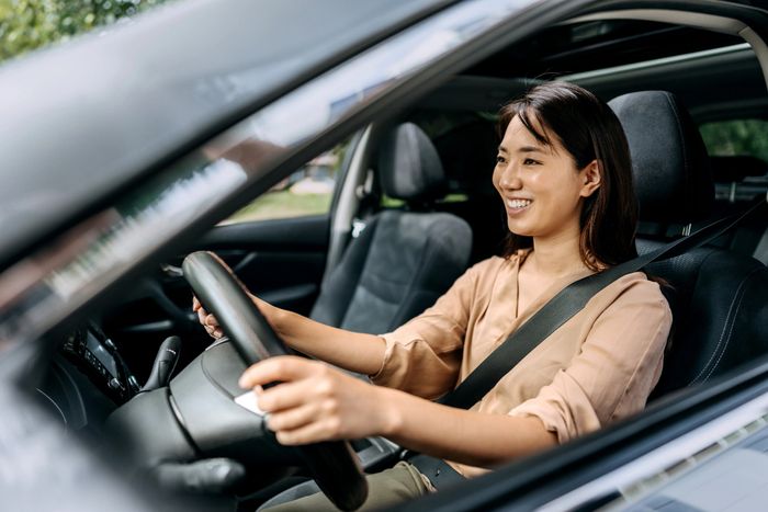 Instructor teaching driving skills using a steering wheel simulator.