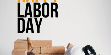 Happy Labor Day with bricks, trowel, and hard hat symbolizing construction work.