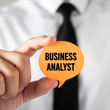Person holding a speech bubble with 'Business Analyst' text.