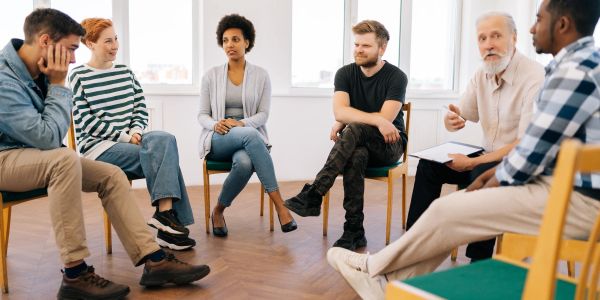 Group therapy session with diverse participants.