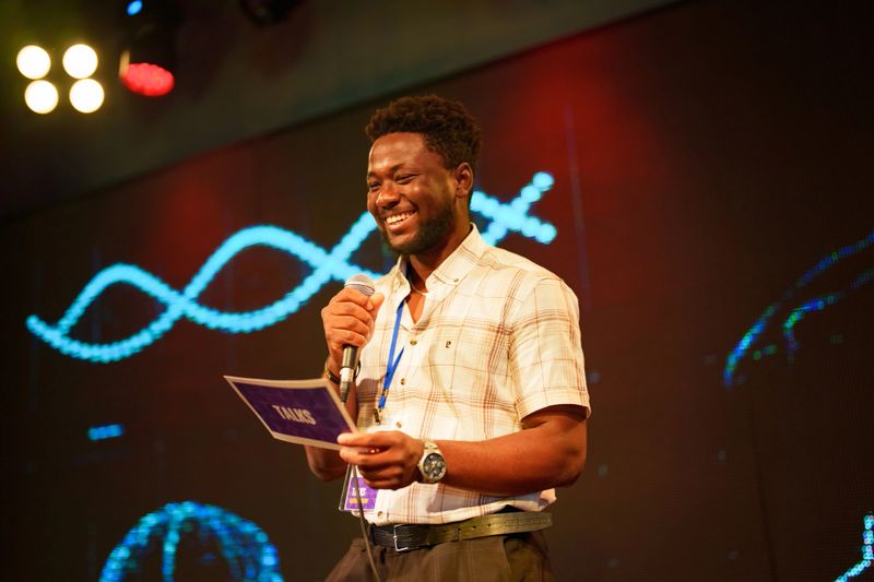 Conference speakers showing presentations on the stage