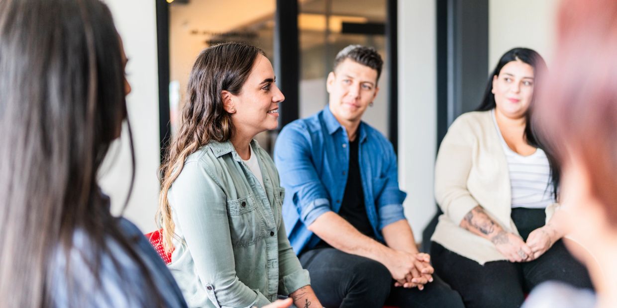 People having a group discussion in a casual setting.