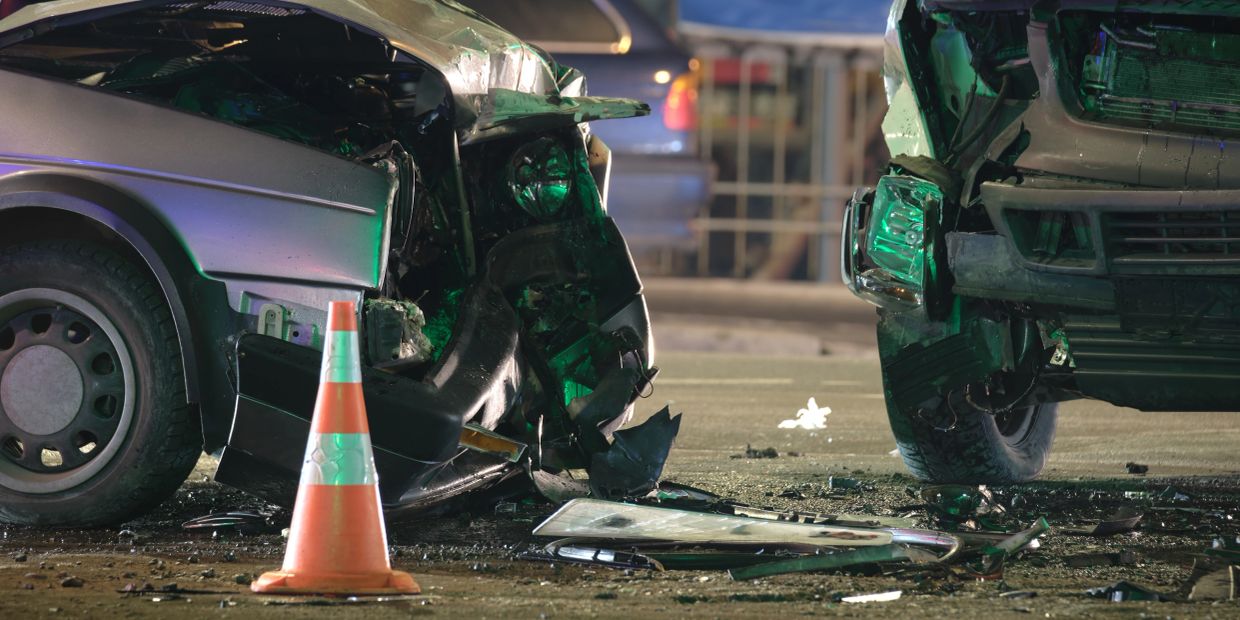 Two cars with front-end damage after a crash on the street.