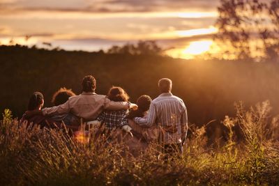 Group watching sunset in nature.