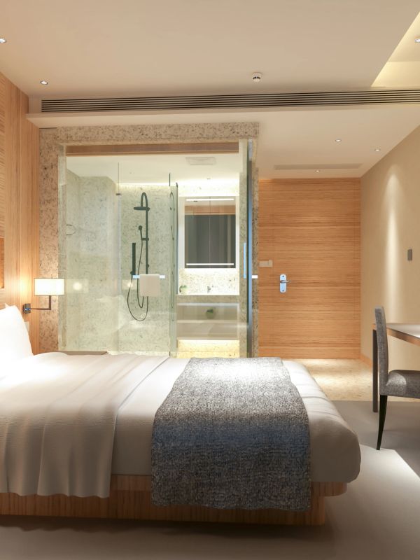 Modern hotel room with wooden accents and glass bathroom.