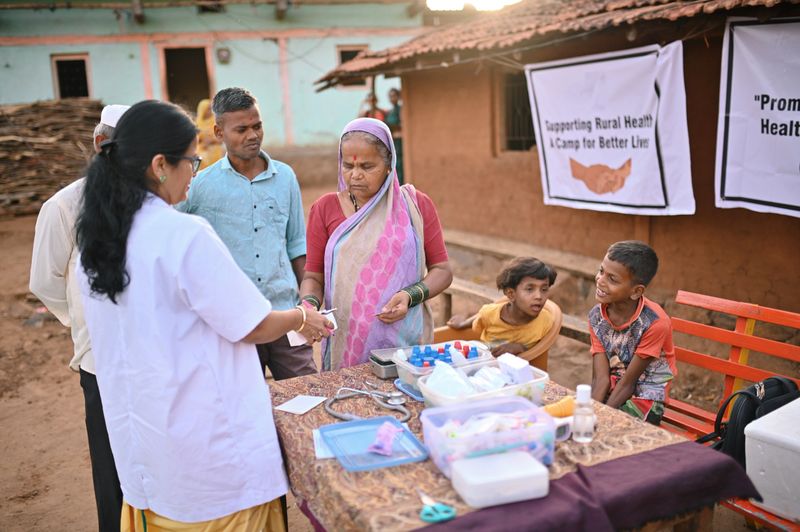 The doctor takes on the role of an educator as she explains the proper dosage of medicine to a village woman. With a warm and caring demeanor, the doctor ensures that the elderly woman understands the importance of adhering to the prescribed dosage. The image captures the dedication of healthcare professionals in reaching out to remote areas and promoting the well-being of individuals who may have limited access to medical care.