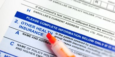 Close-up of a health insurance form with an orange highlighter.