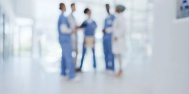 Healthcare professionals in discussion at a hospital, representing hospital discharge services.