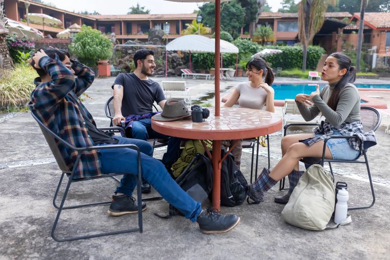 Young people enjoying their stay in their hotel near the pool