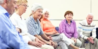 Group of elderly people sitting and talking.