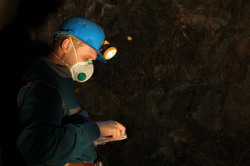 Underground worker, geologist, miner wearing safety equipment.
