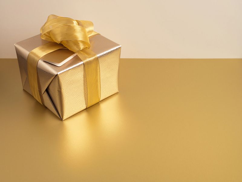 Christmas gift with gold ribbon and gold wrapping