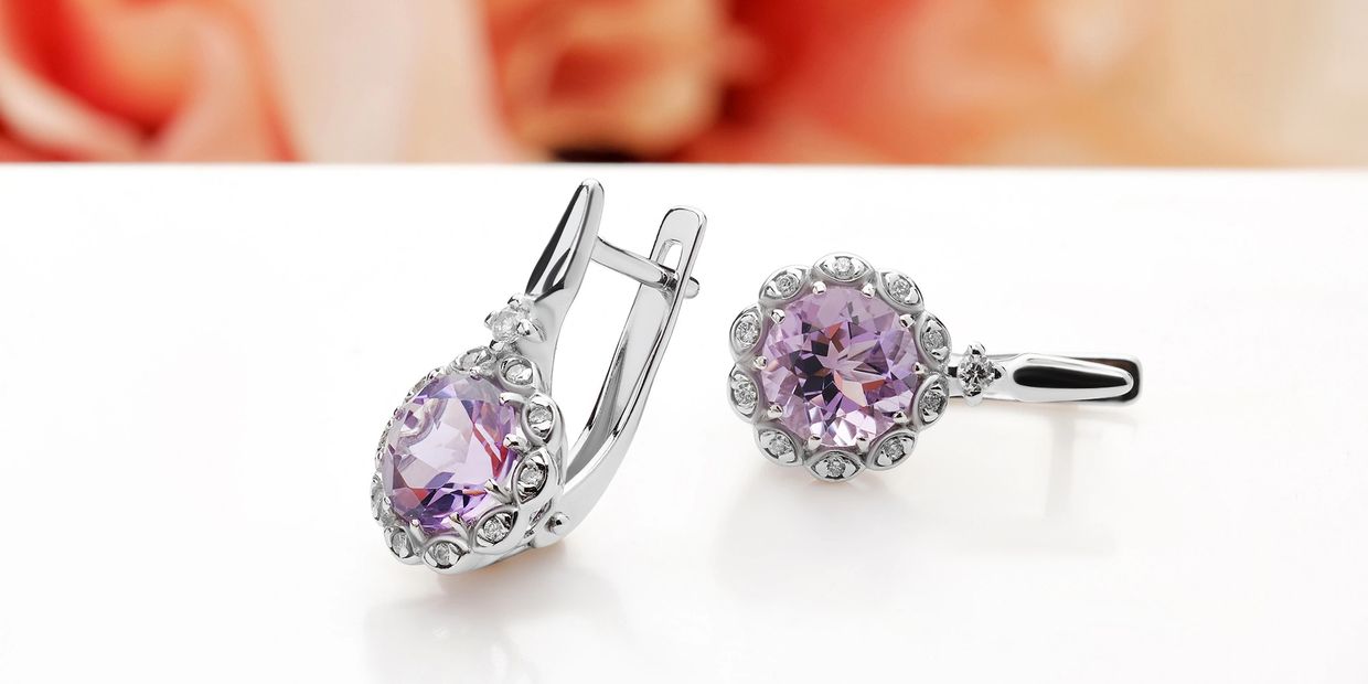 Elegant silver earrings with purple gemstones and diamond accents.