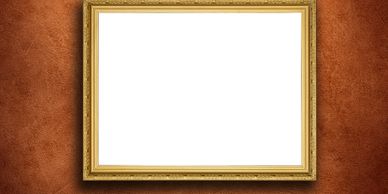 Empty golden picture frame on a textured brown wall.