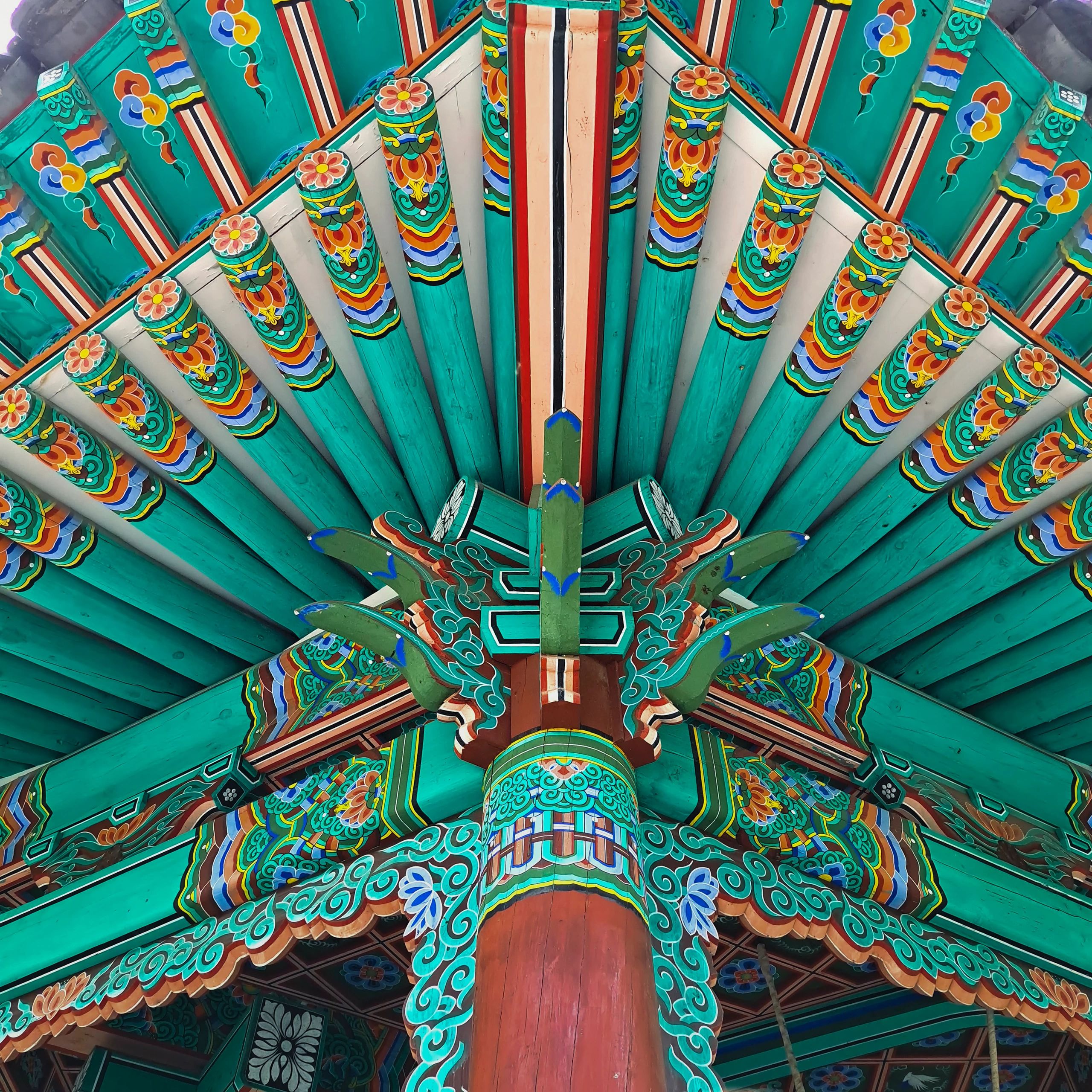 Colorful traditional Korean wooden architecture with intricate floral patterns.