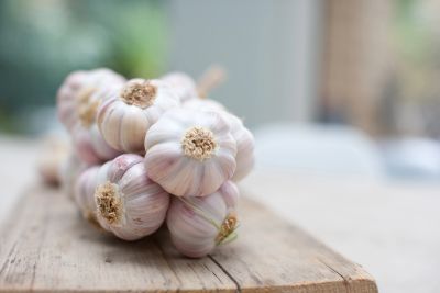 Bunch of garlic bulbs on a wooden surface.