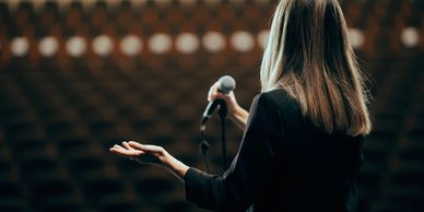 A woman speaking on the stage