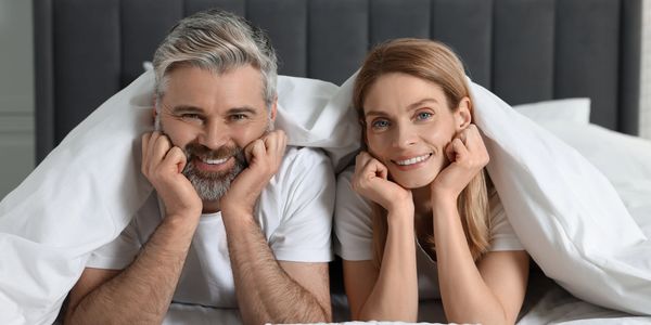 Generic photo of man and women in bed, not patients of Alphagenics TRT & Weight Loss