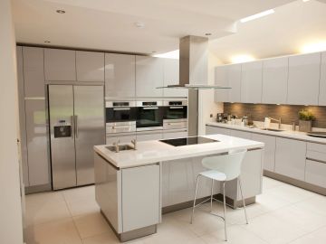 Modern minimalist kitchen with white cabinets and island.