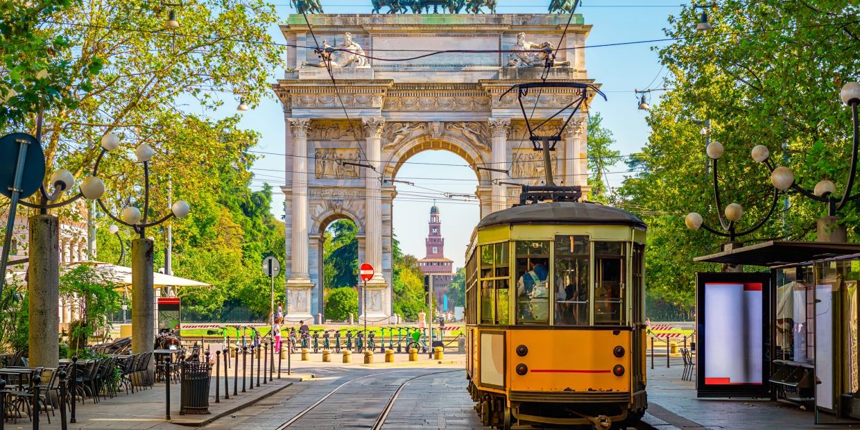 Yellow tram near the Arch of Peace in Milan.
