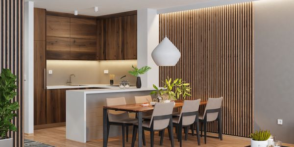 Modern open kitchen and dining area with wood accents and minimalist decor.