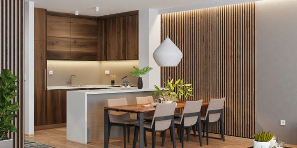 Modern open kitchen and dining area with wood accents and minimalist decor.