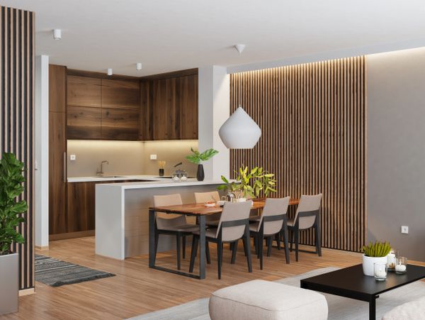 Modern open kitchen and dining area with wood accents and minimalist decor.