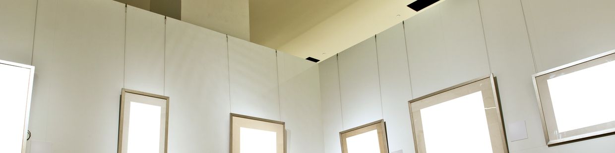 Interior corner with framed windows or mirrors hung on walls.