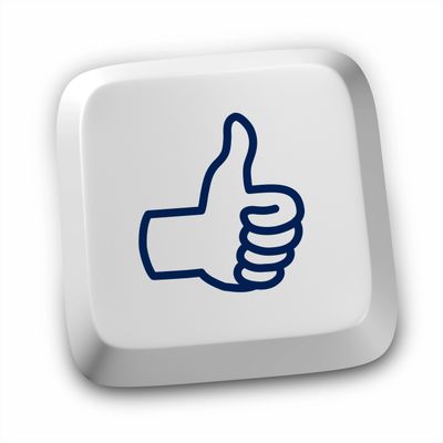 White keyboard key with a blue thumbs-up icon.
