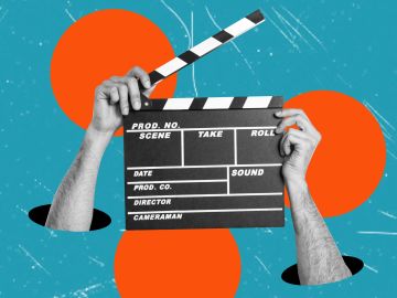 Hands holding a film clapperboard emerging from holes.