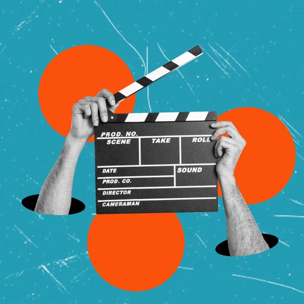 Hands emerging from holes holding a film clapperboard against a blue background with orange circles.