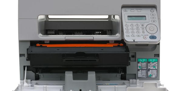 Front view of an open multifunction printer with visible control panel and toner cartridge.
