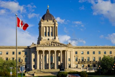 Historic government building with a Canadian flag.