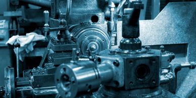 Close-up of a metalworking lathe in an industrial workshop.