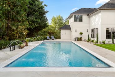 Modern backyard with a rectangular swimming pool.